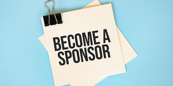 Text become a sponsor on sticky notes with copy space and paper clip isolated on red background.Finance and economics concept.